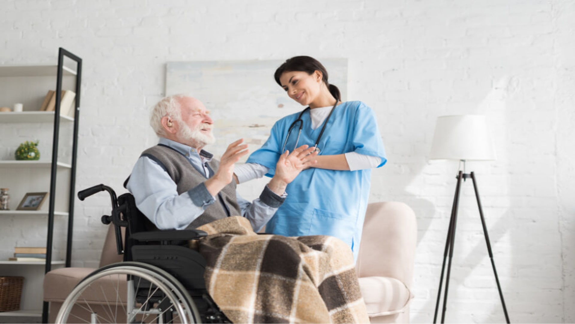 nurse-talking-to-disabled-and-happy-grey-haired-ma-Z9HMVED-min